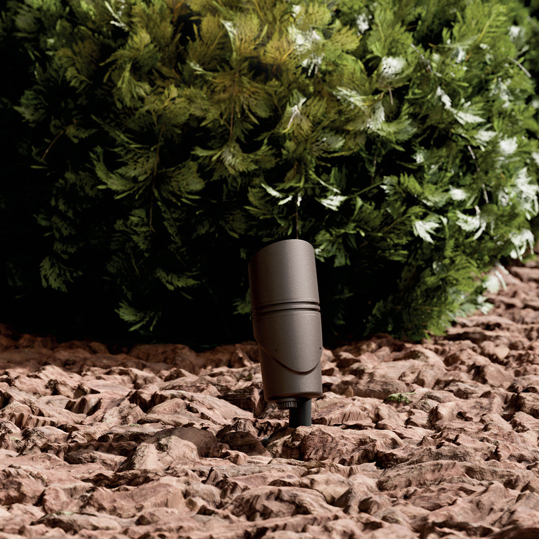 KICHLER Varia 16311 9.8W LED Medium Accent Light Selectable CCT Textured Architectural Bronze installed in landscape, daytime