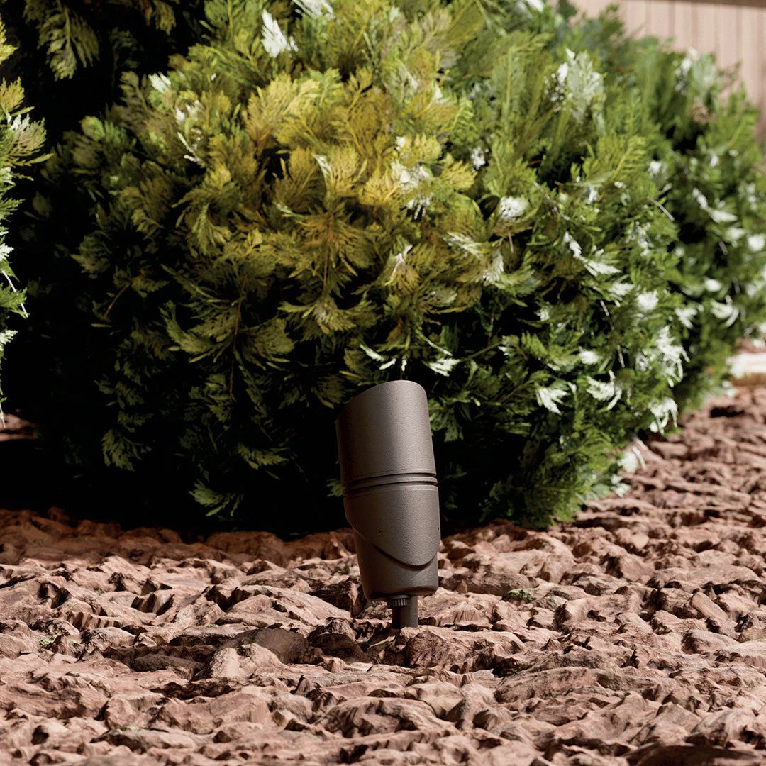 KICHLER Varia 16312 19.6W LED Large Accent Light Selectable CCT Textured Architectural Bronze installed in landscape, daytime